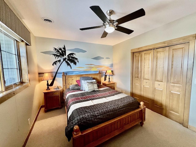 carpeted bedroom featuring baseboards, a ceiling fan, visible vents, and a closet