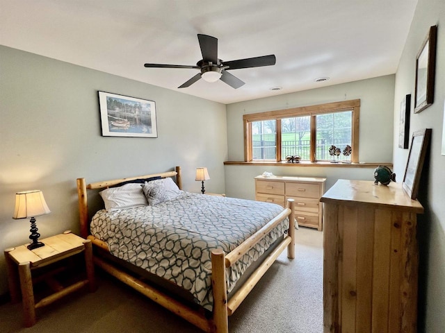 bedroom with light carpet and a ceiling fan