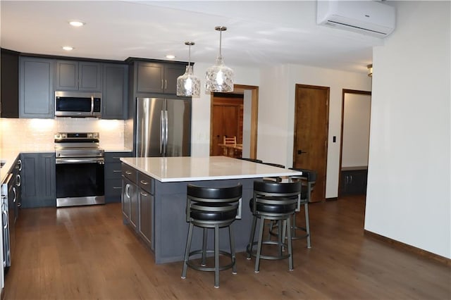 28942 Spring Green Way, Danbury, WI 54830 - kitchen featuring light countertops, an AC wall unit, backsplash, a kitchen island, and appliances with stainless steel finishes