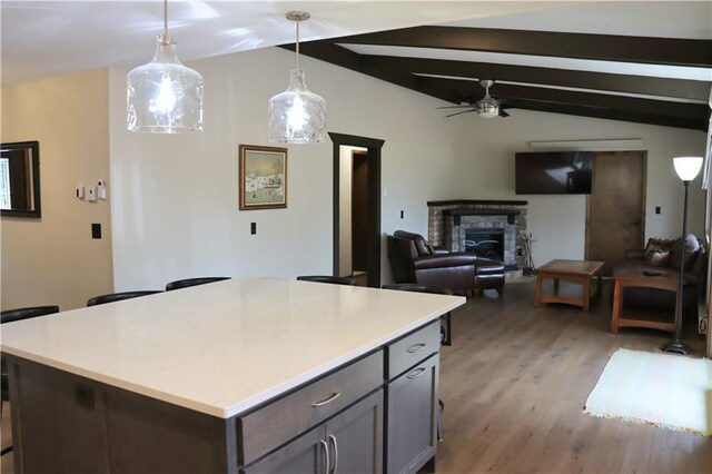 28942 Spring Green Way, Danbury, WI 54830 - kitchen featuring light countertops, vaulted ceiling with beams, hanging light fixtures, and a fireplace