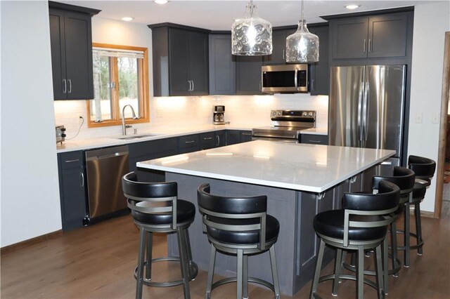 28942 Spring Green Way, Danbury, WI 54830 - kitchen with a sink, stainless steel appliances, dark wood-type flooring, and tasteful backsplash