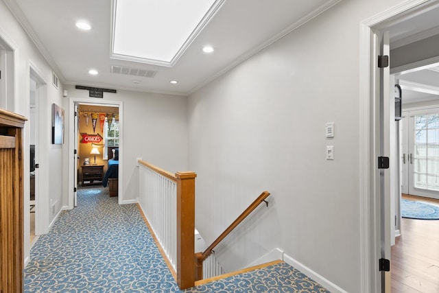 549 Illinois Ave, Green Lake, WI 54941 - hallway with an upstairs landing, visible vents, and ornamental molding