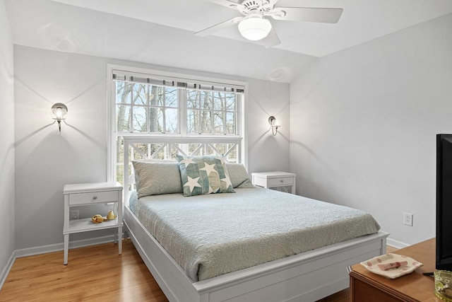 549 Illinois Ave, Green Lake, WI 54941 - bedroom featuring wood finished floors, baseboards, a ceiling fan, and vaulted ceiling
