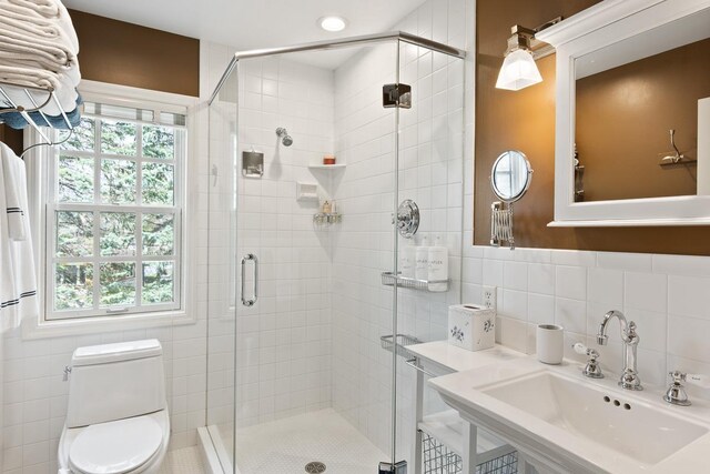 549 Illinois Ave, Green Lake, WI 54941 - bathroom with a sink, tile walls, and a stall shower