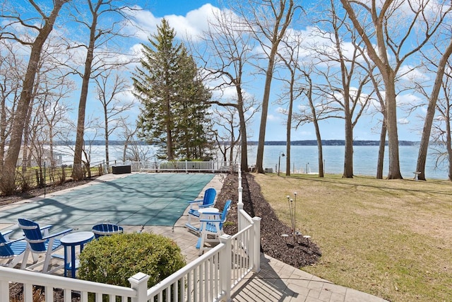 549 Illinois Ave, Green Lake, WI 54941 - exterior space with a water view, fence, and a patio