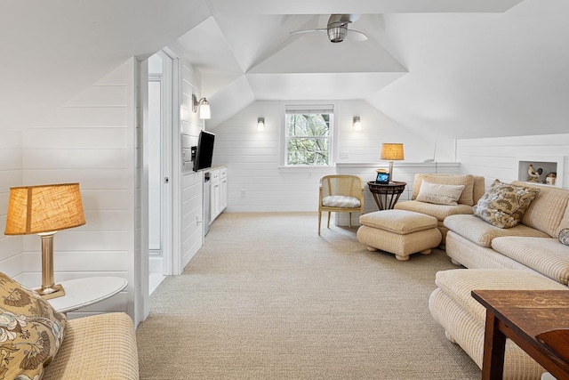 549 Illinois Ave, Green Lake, WI 54941 - living area featuring light carpet, wood walls, ceiling fan, and lofted ceiling