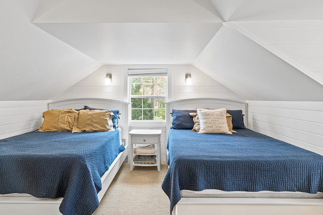 549 Illinois Ave, Green Lake, WI 54941 - carpeted bedroom with wooden walls and vaulted ceiling