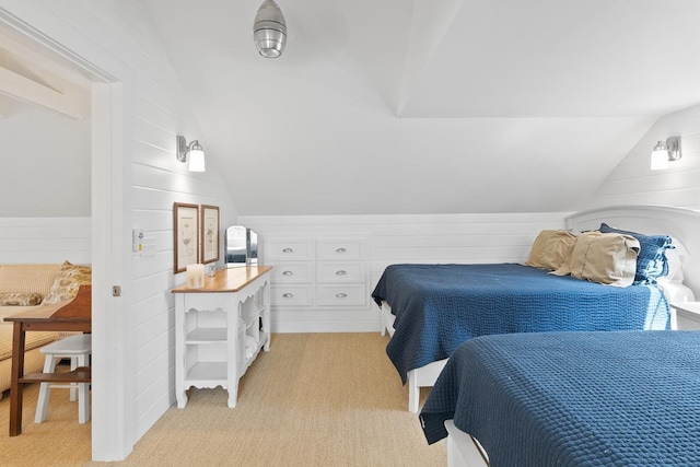 549 Illinois Ave, Green Lake, WI 54941 - bedroom featuring wood walls, vaulted ceiling, and light carpet