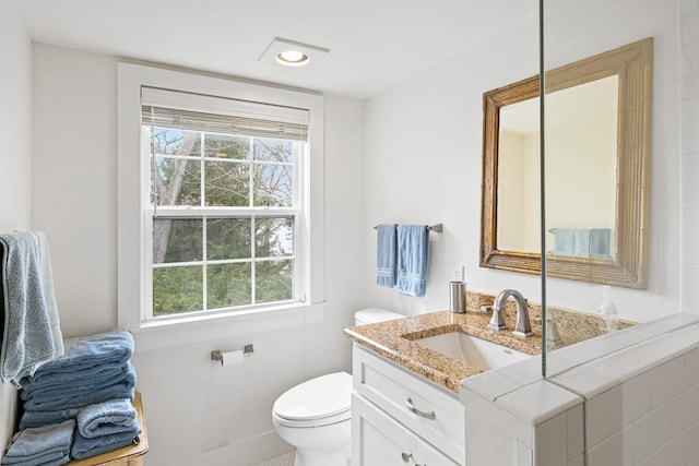 549 Illinois Ave, Green Lake, WI 54941 - bathroom with recessed lighting, vanity, toilet, and a healthy amount of sunlight