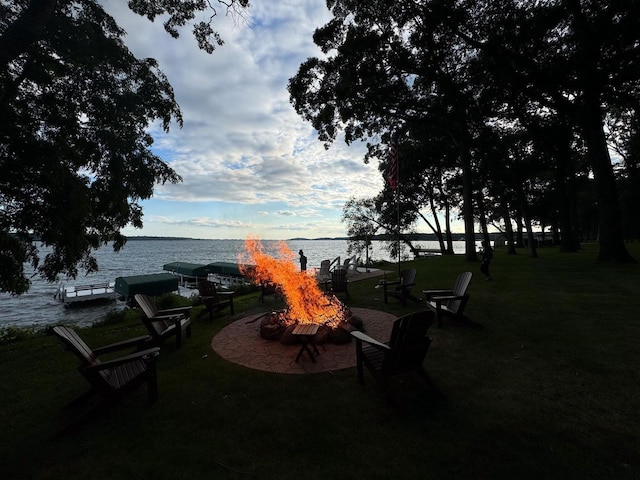549 Illinois Ave, Green Lake, WI 54941 - surrounding community featuring a water view, a boat dock, and a lawn