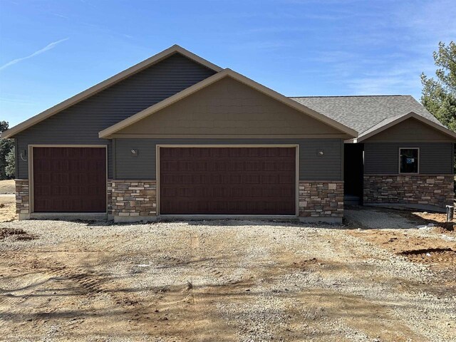 N1647 21st Ave, Wautoma, WI 54982 - view of front of property with stone siding and a garage