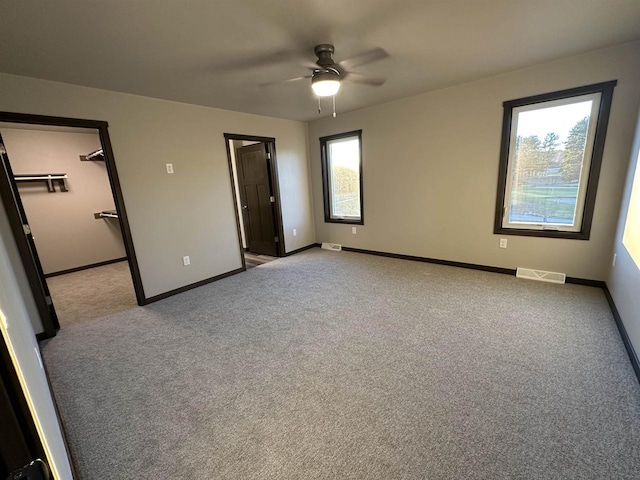 N1647 21st Ave, Wautoma, WI 54982 - unfurnished bedroom with ceiling fan, baseboards, visible vents, and carpet