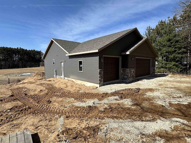 N1647 21st Ave, Wautoma, WI 54982 - view of property exterior with an attached garage and a shingled roof
