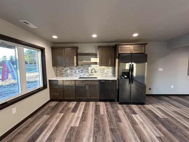 N1647 21st Ave, Wautoma, WI 54982 - kitchen with a sink, visible vents, black dishwasher, stainless steel refrigerator with ice dispenser, and dark wood-type flooring