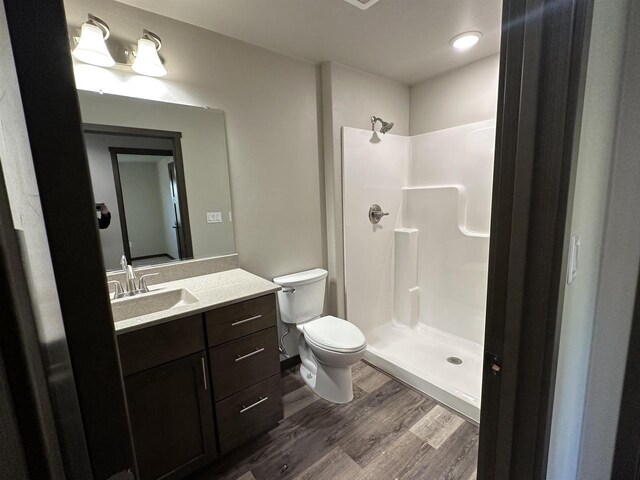 N1647 21st Ave, Wautoma, WI 54982 - full bathroom with a shower stall, wood finished floors, toilet, and vanity
