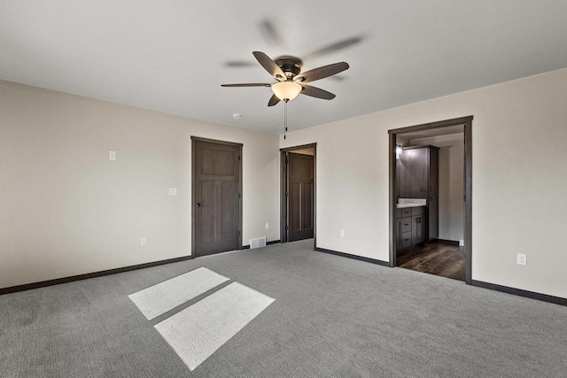 N1647 21st Ave, Wautoma, WI 54982 - unfurnished bedroom featuring baseboards, a ceiling fan, dark colored carpet, and visible vents