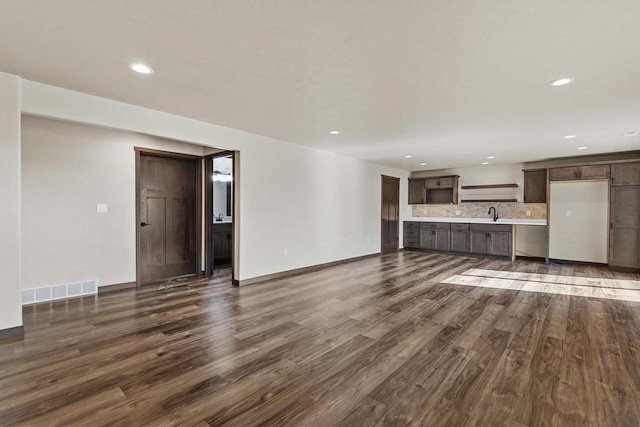 N1647 21st Ave, Wautoma, WI 54982 - unfurnished living room with visible vents, dark wood-style floors, and recessed lighting