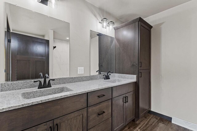 N1647 21st Ave, Wautoma, WI 54982 - bathroom with wood finished floors, visible vents, baseboards, and a sink