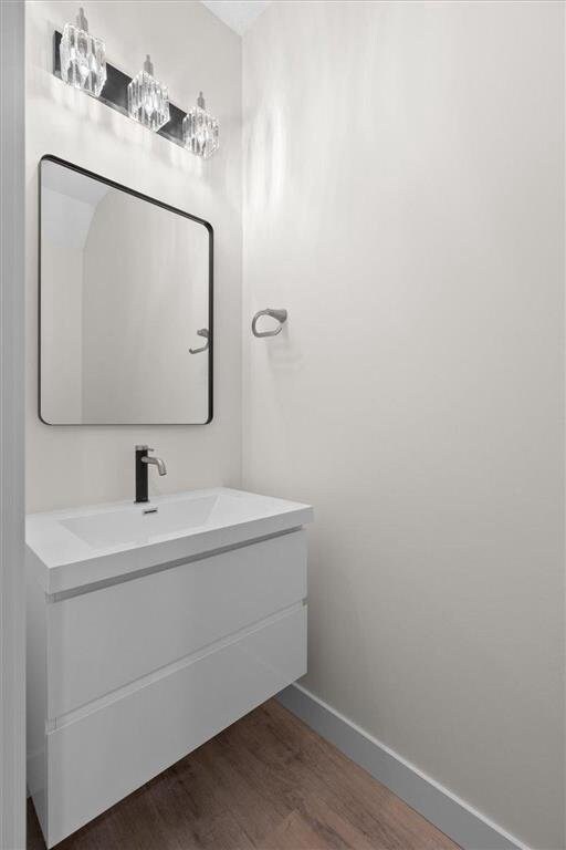 425 W 8th St Unit 20, New Richmond, WI 54017 - bathroom with baseboards, wood finished floors, and vanity