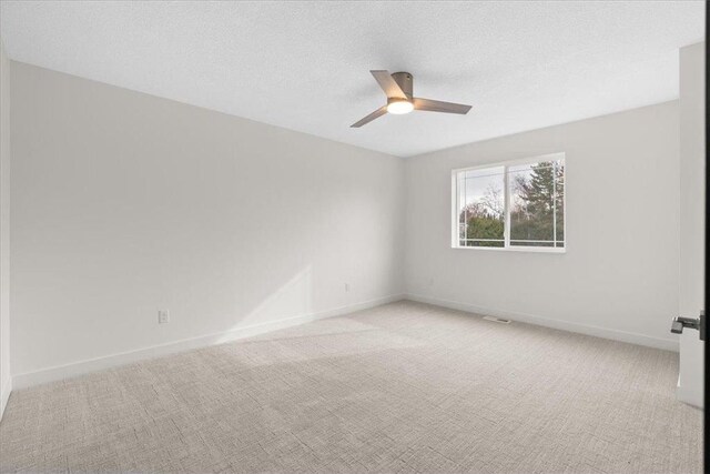 425 W 8th St Unit 20, New Richmond, WI 54017 - unfurnished room with light carpet, baseboards, ceiling fan, and a textured ceiling