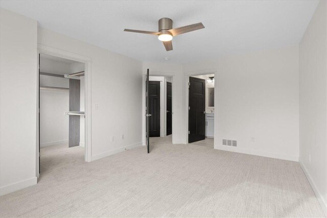425 W 8th St Unit 20, New Richmond, WI 54017 - unfurnished bedroom featuring light carpet, baseboards, visible vents, and a spacious closet