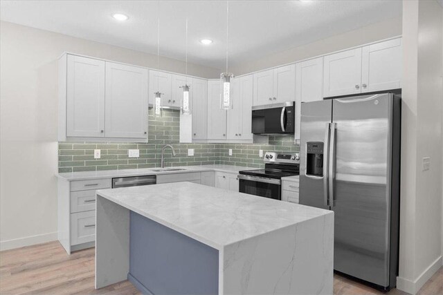 425 W 8th St Unit 20, New Richmond, WI 54017 - kitchen with a sink, tasteful backsplash, appliances with stainless steel finishes, light wood-style flooring, and white cabinets