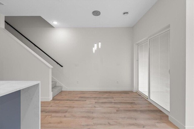 425 W 8th St Unit 20, New Richmond, WI 54017 - interior space featuring baseboards, stairway, visible vents, and light wood-style floors
