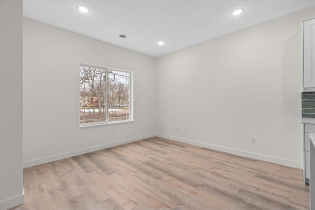 425 W 8th St Unit 20, New Richmond, WI 54017 - empty room with baseboards, light wood-style flooring, and recessed lighting