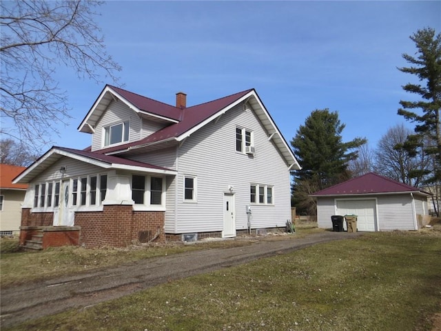 204 W Main St, Thorp, WI 54771 - exterior space featuring a chimney, an outbuilding, aphalt driveway, a lawn, and a garage