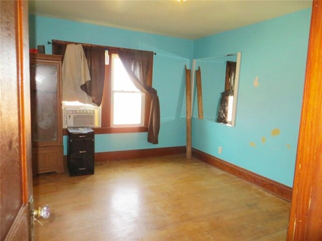 204 W Main St, Thorp, WI 54771 - unfurnished bedroom featuring baseboards, wood finished floors, and cooling unit