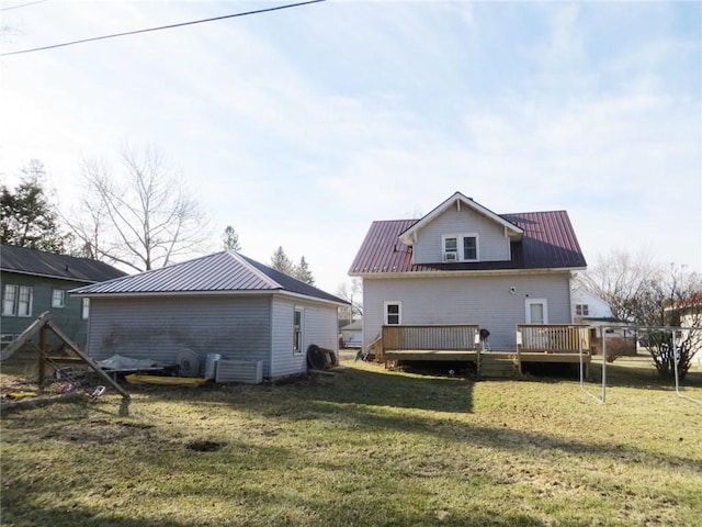 204 W Main St, Thorp, WI 54771 - rear view of property featuring metal roof, a deck, and a lawn