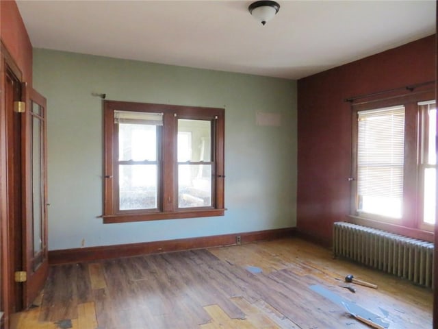 204 W Main St, Thorp, WI 54771 - unfurnished room featuring baseboards, wood finished floors, and radiator heating unit