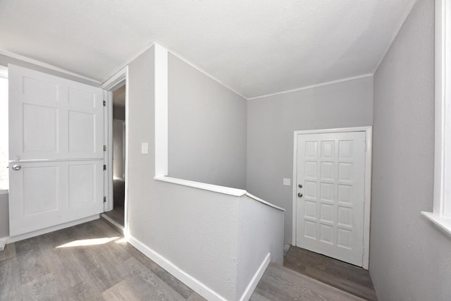 interior space with baseboards and wood finished floors