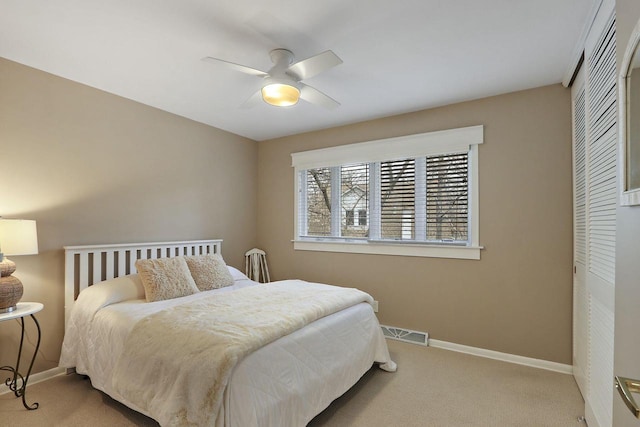 831 Sauganash Dr, Fontana, WI 53125 - carpeted bedroom with baseboards, a closet, ceiling fan, and visible vents
