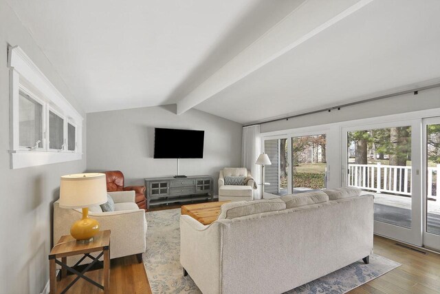 831 Sauganash Dr, Fontana, WI 53125 - living room featuring lofted ceiling with beams, visible vents, and wood finished floors