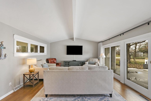 831 Sauganash Dr, Fontana, WI 53125 - living room with baseboards, lofted ceiling with beams, visible vents, and wood finished floors