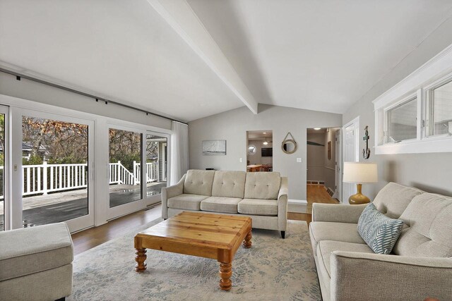 831 Sauganash Dr, Fontana, WI 53125 - living room featuring vaulted ceiling with beams and wood finished floors