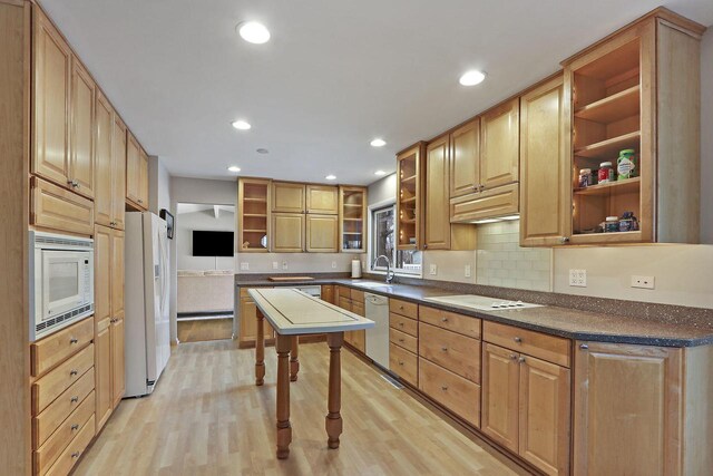 831 Sauganash Dr, Fontana, WI 53125 - kitchen featuring open shelves, light wood-style floors, dark countertops, and white appliances