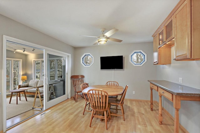 831 Sauganash Dr, Fontana, WI 53125 - dining area featuring visible vents, light wood-style flooring, a ceiling fan, and plenty of natural light