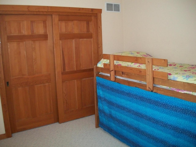 bedroom with light colored carpet and visible vents