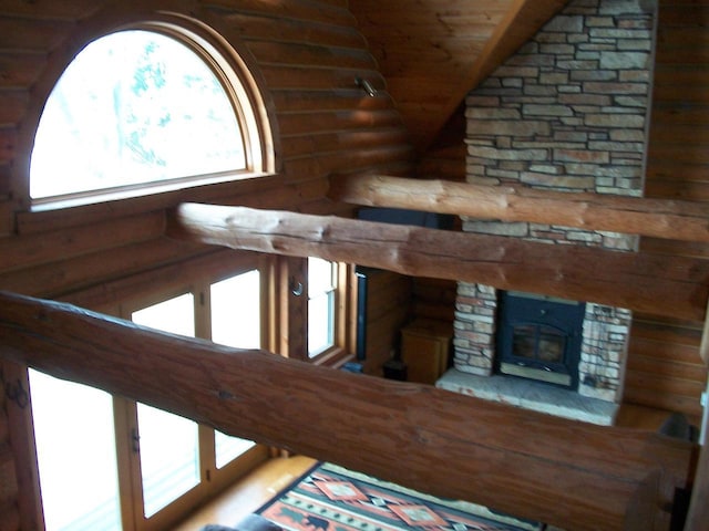 interior space with rustic walls and a stone fireplace