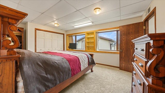 712 Water St, Genoa, WI 54632 - bedroom with carpet flooring, baseboards, a closet, and a paneled ceiling