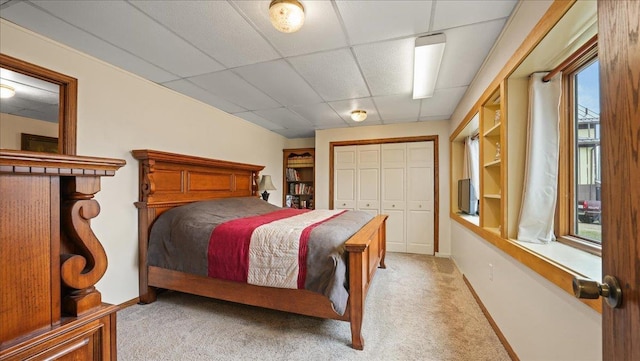 712 Water St, Genoa, WI 54632 - bedroom featuring a drop ceiling, light carpet, baseboards, and a closet