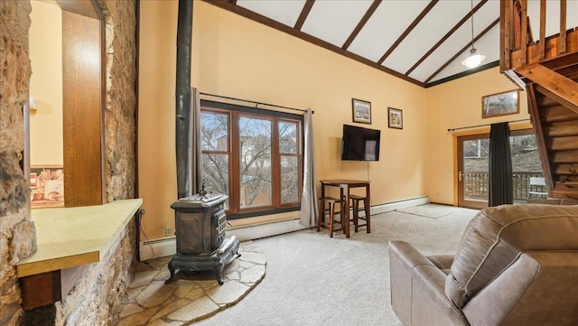 712 Water St, Genoa, WI 54632 - living area with baseboard heating, high vaulted ceiling, a wood stove, and carpet