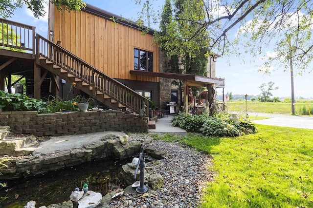 712 Water St, Genoa, WI 54632 - exterior space with a yard, a patio area, stairs, and a wooden deck