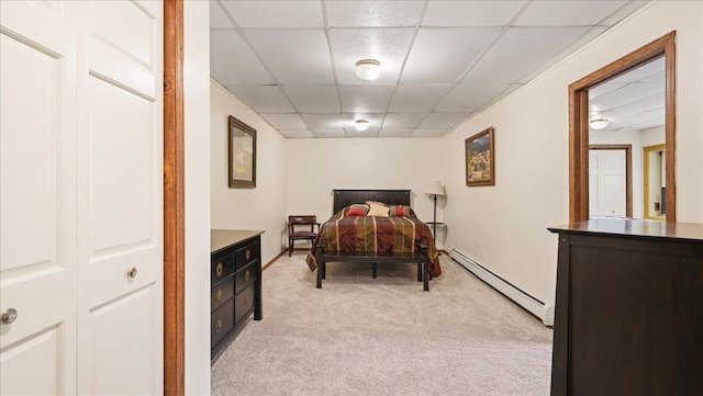 712 Water St, Genoa, WI 54632 - bedroom with light carpet, baseboards, a baseboard heating unit, and a paneled ceiling