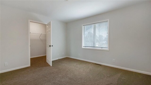 27183 250th St, Holcombe, WI 54745 - unfurnished bedroom featuring a closet, carpet flooring, visible vents, baseboards, and a spacious closet