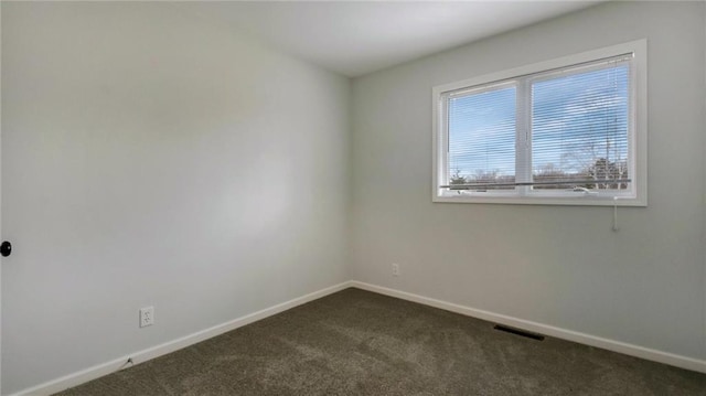 27183 250th St, Holcombe, WI 54745 - spare room featuring baseboards, dark colored carpet, and visible vents
