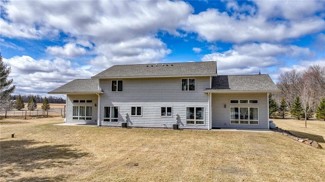 27183 250th St, Holcombe, WI 54745 - rear view of house featuring roof with shingles, a yard, and a patio area