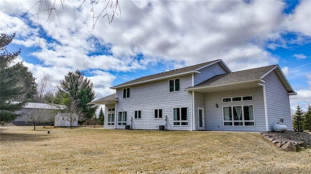 27183 250th St, Holcombe, WI 54745 - back of house with an outbuilding, a shed, a yard, and a shingled roof
